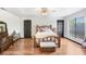 Bright bedroom featuring wood floors, rustic wood bedframe, and natural light, creating a peaceful retreat at 7321 Caladesia Dr, Sarasota, FL 34243