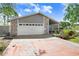Charming single-story home featuring stone accents, a two-car garage, and a well-manicured front yard at 7321 Caladesia Dr, Sarasota, FL 34243