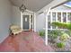 Cozy front porch with a decorative hanging lantern, bench seating, and elegant entryway at 7321 Caladesia Dr, Sarasota, FL 34243