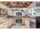 Charming kitchen with rustic cabinets, stone countertops, and stainless steel appliances, creating a cozy and functional space at 7321 Caladesia Dr, Sarasota, FL 34243