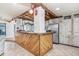 Spacious kitchen with a large wooden island, rustic cabinets, and stainless steel appliances at 7321 Caladesia Dr, Sarasota, FL 34243