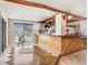 Open kitchen with an island breakfast bar, hardwood floors, and black-framed windows, creating a bright atmosphere at 7321 Caladesia Dr, Sarasota, FL 34243
