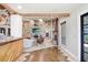 Open living room with stone fireplace and wood beams at 7321 Caladesia Dr, Sarasota, FL 34243