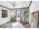 Bright room featuring wall art, a large window, and gray laminate flooring at 7321 Caladesia Dr, Sarasota, FL 34243