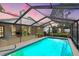 Inviting screened-in pool area perfect for relaxation and entertainment, surrounded by lush landscaping at 7321 Caladesia Dr, Sarasota, FL 34243