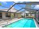 Inviting screened-in pool area perfect for relaxation and entertainment, surrounded by lush landscaping at 7321 Caladesia Dr, Sarasota, FL 34243