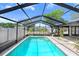 View of the sparkling pool enclosed within a screened patio, offering privacy and shade at 7321 Caladesia Dr, Sarasota, FL 34243
