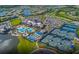 Aerial view featuring the community pool, tennis courts, lake access, and other outdoor amenities at 7327 Summerland Cv, Bradenton, FL 34202
