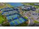 Aerial view of the tennis courts and community pool area with convenient parking and beautifully maintained landscaping at 7327 Summerland Cv, Bradenton, FL 34202