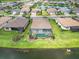 Community aerial view showcases lakefront homes, mature landscaping, and a serene atmosphere at 7327 Summerland Cv, Bradenton, FL 34202