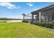 Lush backyard with beautiful lake view, screened lanai, and well-maintained landscaping at 7327 Summerland Cv, Bradenton, FL 34202