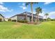 Expansive backyard with lush lawn and a screened-in lanai, perfect for outdoor enjoyment at 7327 Summerland Cv, Bradenton, FL 34202