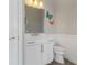 Charming powder room featuring a white vanity, marble countertop, and decorative wall butterflies at 7327 Summerland Cv, Bradenton, FL 34202