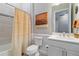 This bathroom features wainscotting, tile flooring, and a shower tub combo at 7327 Summerland Cv, Bradenton, FL 34202