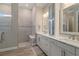 Beautiful bathroom featuring a walk-in shower and double vanity with white cabinets at 7327 Summerland Cv, Bradenton, FL 34202
