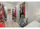 Walk-in closet with custom shelving and organization systems for ample storage space at 7327 Summerland Cv, Bradenton, FL 34202