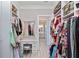 Walk-in closet with custom cabinets, drawers, a vanity, and plenty of storage space at 7327 Summerland Cv, Bradenton, FL 34202