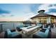 Outdoor lounging area and lakeside views from the beautiful community clubhouse at sunset at 7327 Summerland Cv, Bradenton, FL 34202