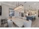 Open-concept dining room and kitchen with modern lighting and stainless steel appliances at 7327 Summerland Cv, Bradenton, FL 34202