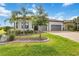 Charming home with manicured lawn, mature trees, and a spacious two-car garage at 7327 Summerland Cv, Bradenton, FL 34202
