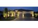 Beautifully illuminated home featuring a stone facade, tile roof, and two-car garage at 7327 Summerland Cv, Bradenton, FL 34202