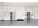 Well-organized garage with ample cabinet space and stainless steel refrigerator, with epoxy flooring at 7327 Summerland Cv, Bradenton, FL 34202