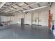 Spacious garage with epoxy flooring, built-in cabinets, and plenty of room for storage at 7327 Summerland Cv, Bradenton, FL 34202