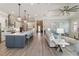 Open-concept kitchen with stainless appliances, central island, and clear sight lines to living area at 7327 Summerland Cv, Bradenton, FL 34202