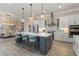 Bright kitchen with island, stainless appliances, tile backsplash, and pendant lighting at 7327 Summerland Cv, Bradenton, FL 34202