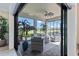 Spacious lanai with comfortable seating area and views of lush landscaping and a beautiful lawn at 7327 Summerland Cv, Bradenton, FL 34202