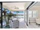Relaxing screened-in lanai with comfortable seating and views of the pool and lake at 7327 Summerland Cv, Bradenton, FL 34202