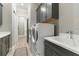 Well-equipped laundry room featuring modern washer and dryer units and plenty of storage at 7327 Summerland Cv, Bradenton, FL 34202