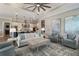 Open-concept living room with neutral tones, recessed lights, and ceiling fan at 7327 Summerland Cv, Bradenton, FL 34202
