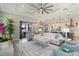 Bright open-concept living space with direct access to the outdoor patio and kitchen at 7327 Summerland Cv, Bradenton, FL 34202