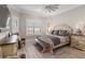 Cozy main bedroom featuring a ceiling fan, bench at the foot of the bed, and neutral paint at 7327 Summerland Cv, Bradenton, FL 34202