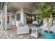 Relaxing outdoor patio with stylish seating, ceiling fans, and a built-in bar area at 7327 Summerland Cv, Bradenton, FL 34202