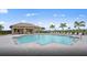 Luxury community pool featuring a spacious layout and ample seating for residents at 7327 Summerland Cv, Bradenton, FL 34202