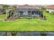 Screened-in lanai features a pool, lush landscaping, and access to a serene waterfront view at 7327 Summerland Cv, Bradenton, FL 34202