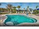 A community pool features an ADA lift, seating areas, and tropical landscaping at 7327 Summerland Cv, Bradenton, FL 34202
