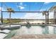 Stunning pool and spa area with a serene lake view, perfect for relaxation at 7327 Summerland Cv, Bradenton, FL 34202