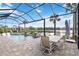 Beautiful pool area with outdoor dining, lake view, and relaxing atmosphere at 7327 Summerland Cv, Bradenton, FL 34202