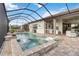 Luxurious screened-in pool and spa with outdoor bar and comfortable seating area at 7327 Summerland Cv, Bradenton, FL 34202
