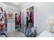 Custom walk-in closet with extensive shelving, hanging rods, drawers, and a stylish chandelier at 7327 Summerland Cv, Bradenton, FL 34202