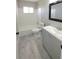 Updated bathroom featuring a modern vanity, tiled floor, and a shower-tub combination with a window at 7524 Kavanda St, North Port, FL 34287