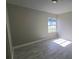 Cozy bedroom with a window, tile flooring, and neutral paint at 7524 Kavanda St, North Port, FL 34287
