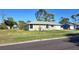 Charming single-story home with a well-maintained lawn, landscaping, and attached garage at 7524 Kavanda St, North Port, FL 34287