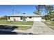 Well-maintained single-story home with a green lawn, tidy landscaping, and an attached garage at 7524 Kavanda St, North Port, FL 34287
