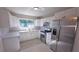 Modern kitchen with white cabinets, quartz countertops, and stainless steel appliances at 7524 Kavanda St, North Port, FL 34287
