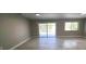 Open living room with sliding glass doors and tile floors, providing access to outdoor area at 7524 Kavanda St, North Port, FL 34287