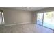 Bright living room with sliding doors, a view of the pool, and tile floors at 7524 Kavanda St, North Port, FL 34287